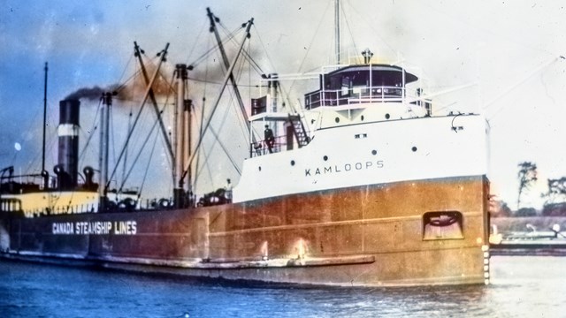 SS Kamloops navigating out of a harbor, smoke billowing