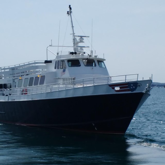 A large ferry boat called 'Isle Royale Queen IV' on open water