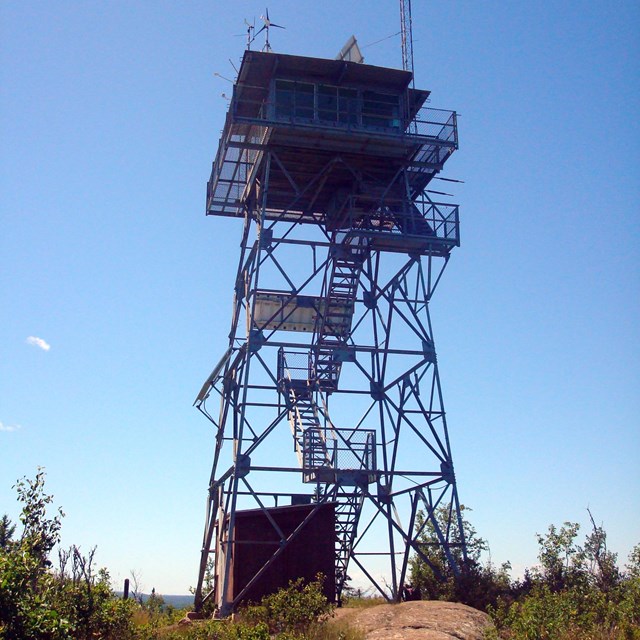 Ojibway tower with a dirt trail leading to it.