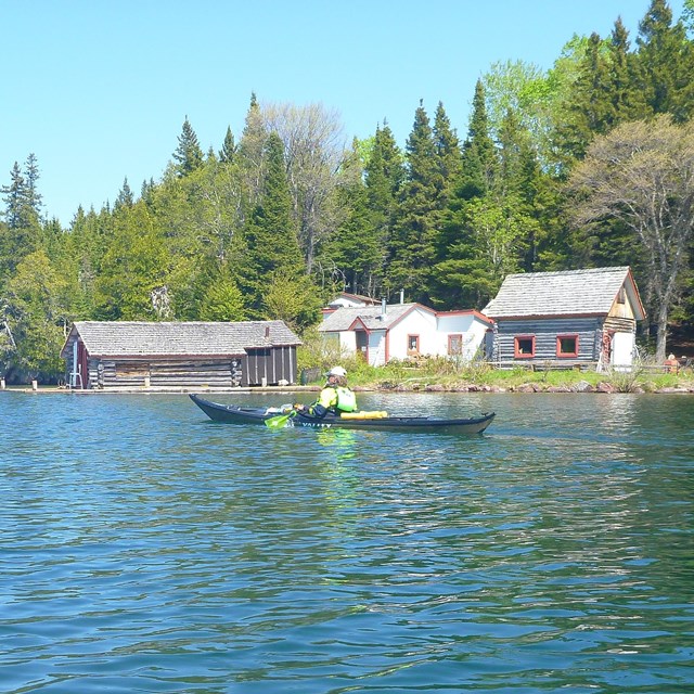A kayaker paddling past Edisen Fishery.