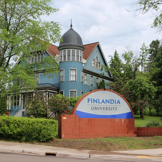 A photo shows a Finlandia sign with a building in the background