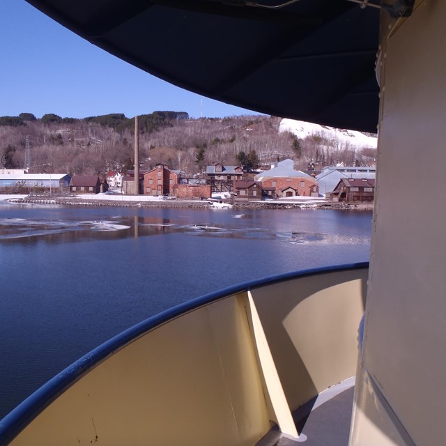 View of the Quincy Smelter from the Ranger III across the icy spring water of the Keweenaw Waterway.