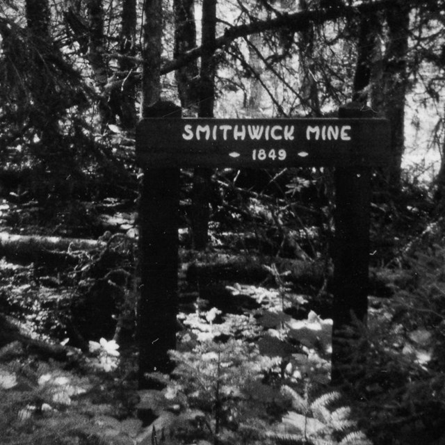 sign in forest noting minesite location