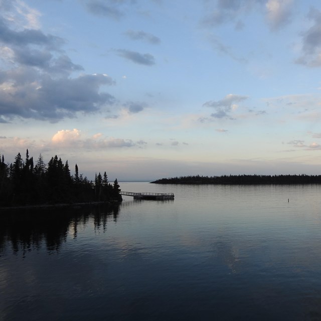 The sunrising in the Rock Harbor Channel looking out to Lake Superior and small islands. 