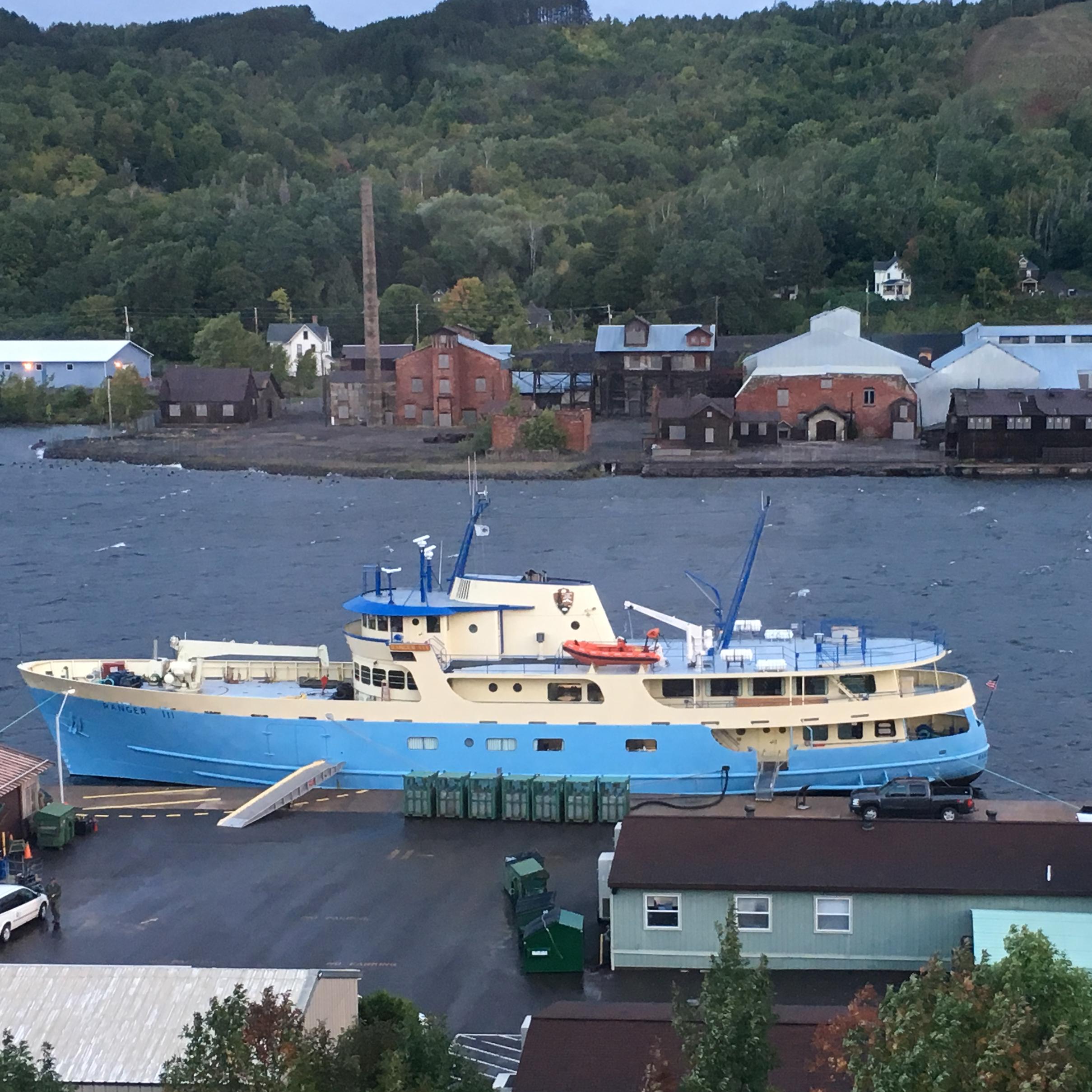 RANGER III passenger ferry at dock in Houghton Michigan as seem from a distance atop a hill. 