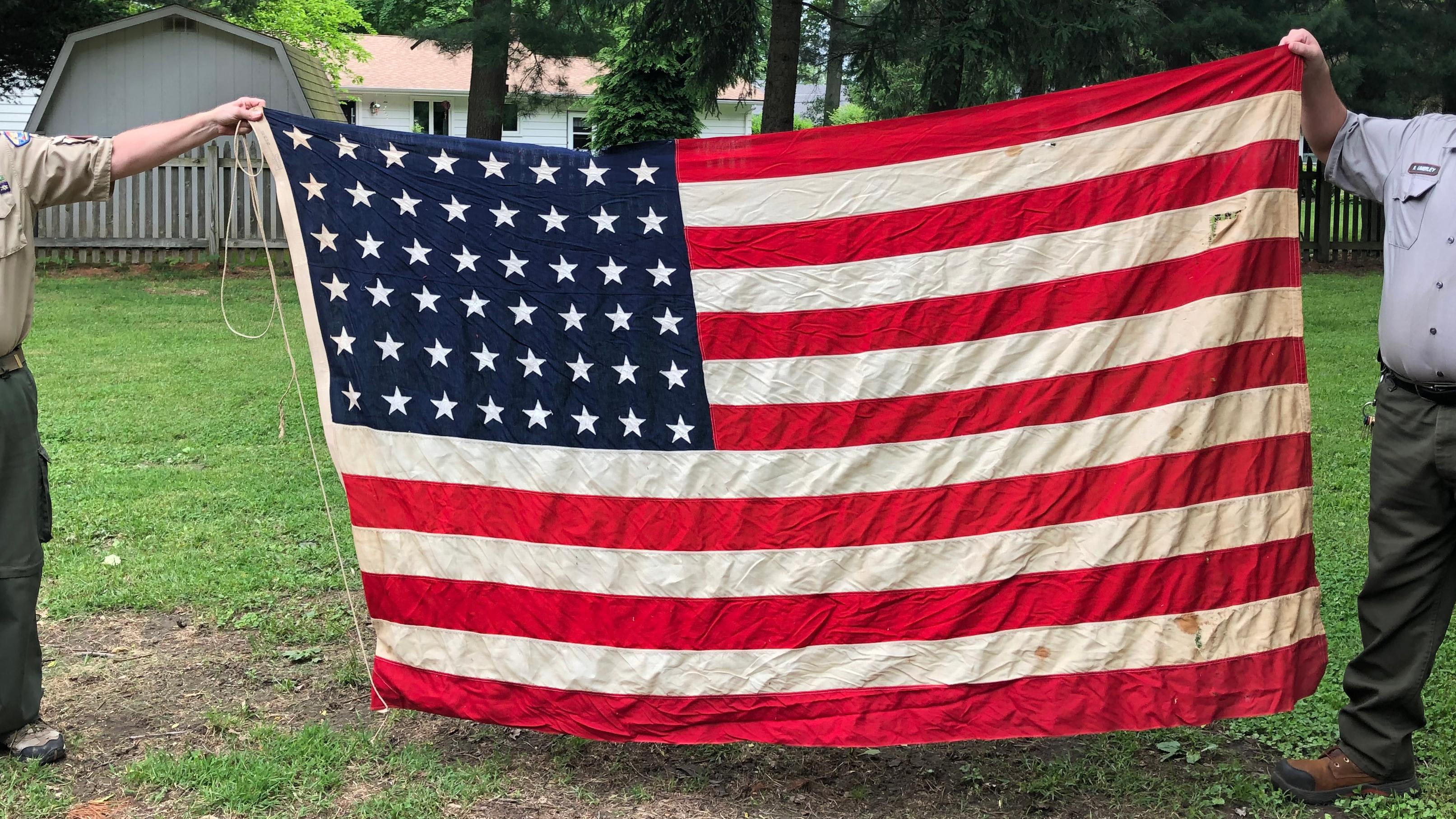 Scouts folding an American flag