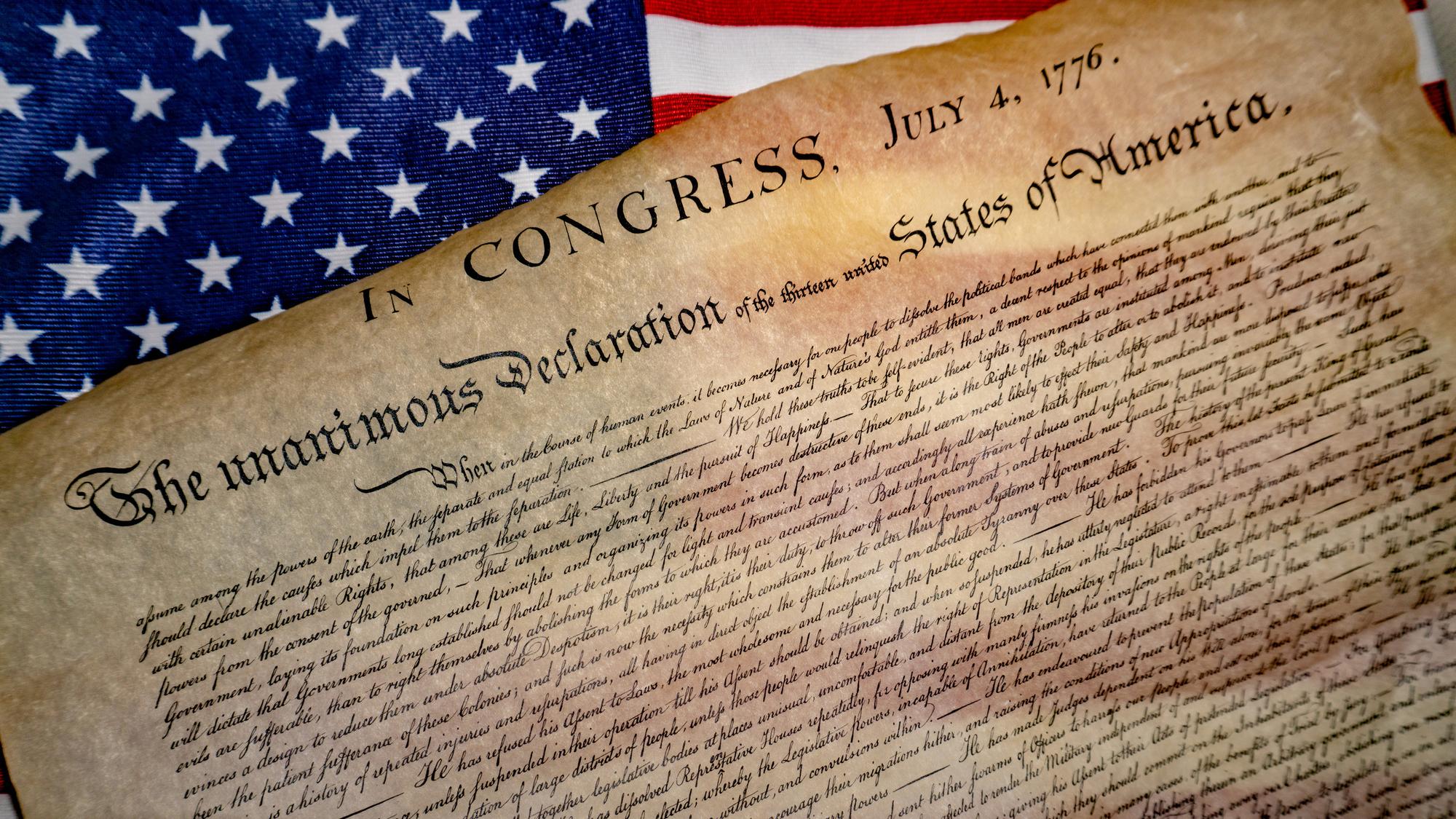 Declaration of Independence draped over an American flag.