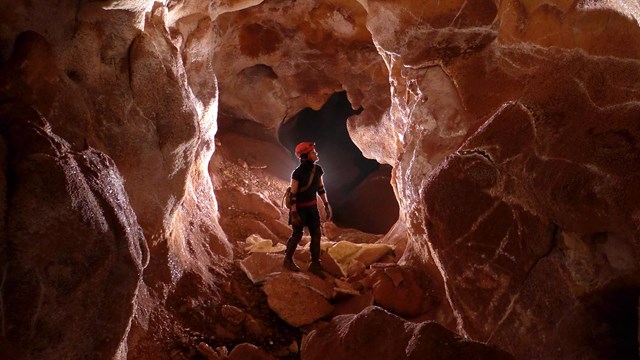 A cave explorer inside a large cavern.