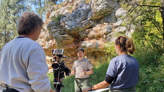 A park ranger prepares to be filmed in Lithograph Canyon for a video podcast.