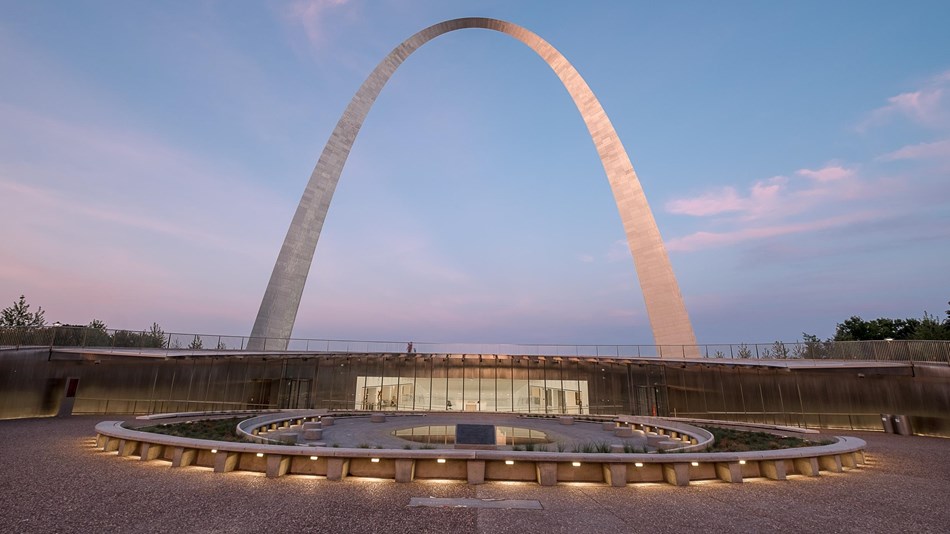 the Gateway Arch rises up behind the new glass entrance 