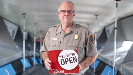 Visitors enjoy the top of the Arch with facemasks and plexiglass barriers