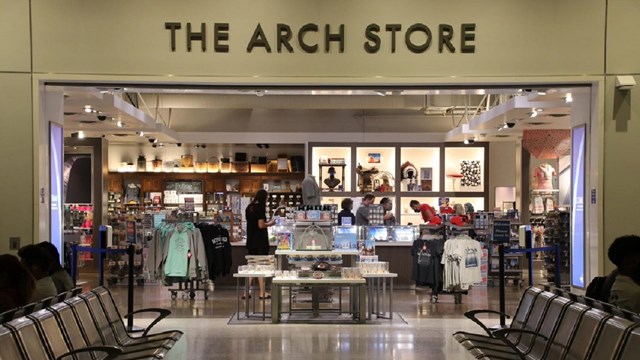 The entryway to the Arch Store at the Gateway Arch. Several racks of merchandise are visible.