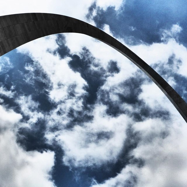 Photo of top part of the Arch and clouds