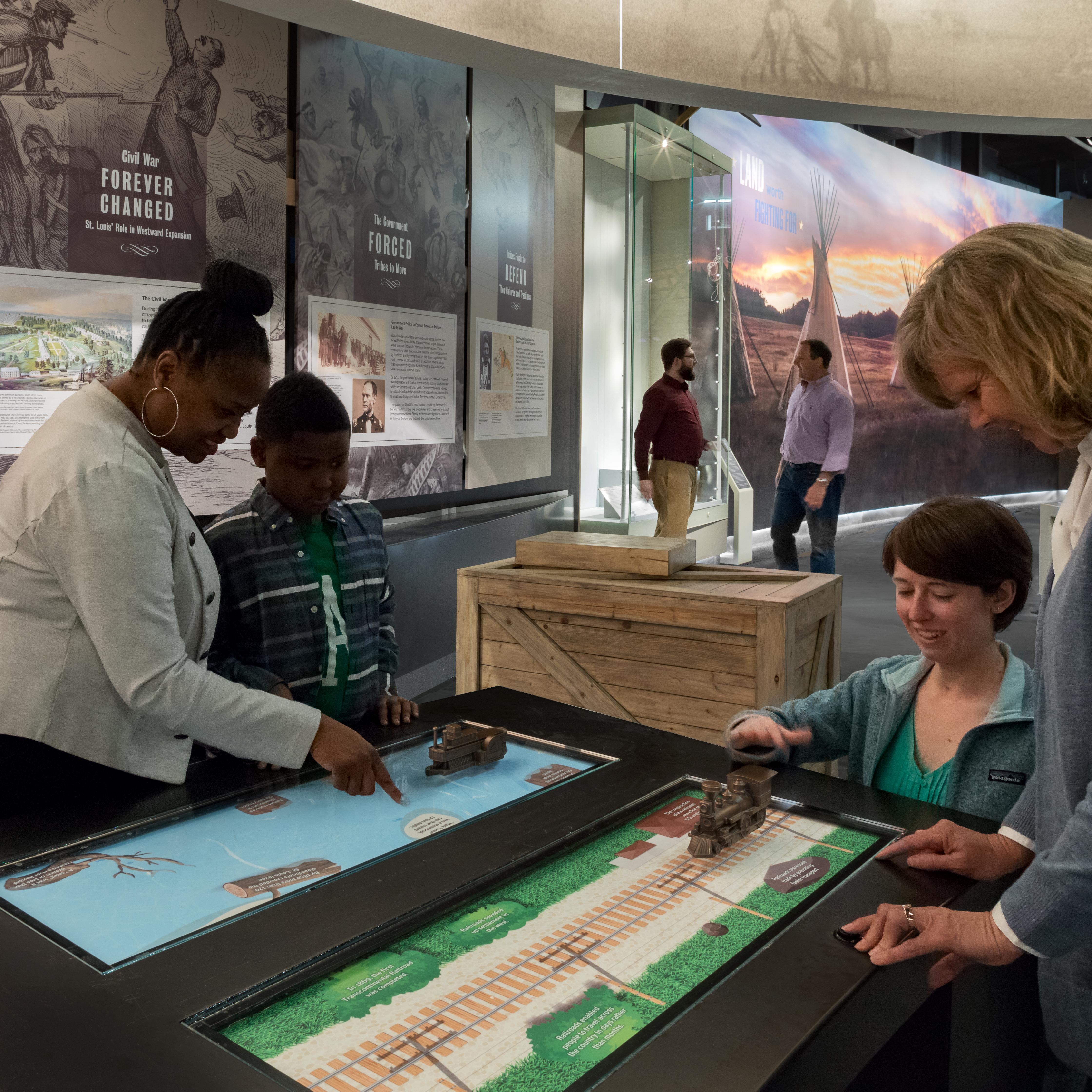 people using interactive screen in New Frontiers gallery