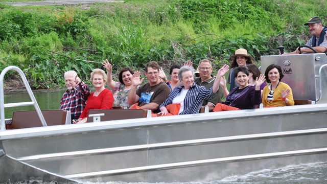 People on a Boat tour with 2 rangers on Bayou Lafourche