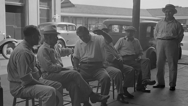 italian men sit on decatur street corner historic photo