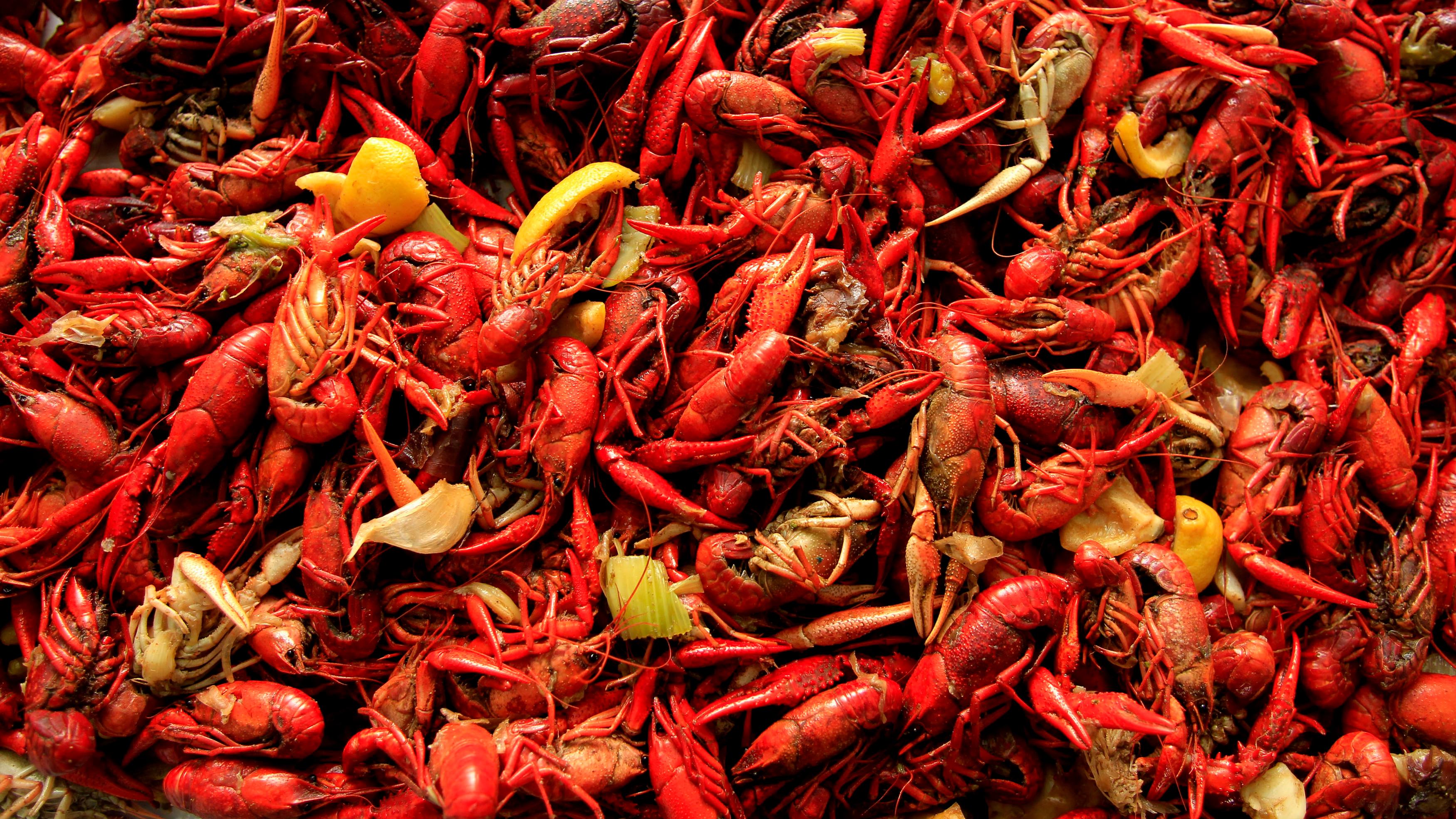 a pile of boiled crawfish with citrus and seasonings