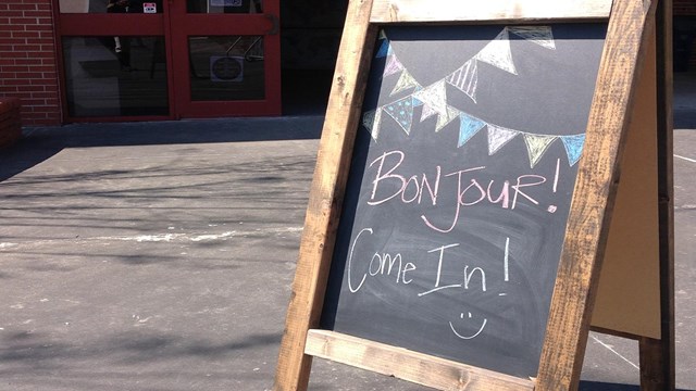 blackboard a frame that says bonjour come in