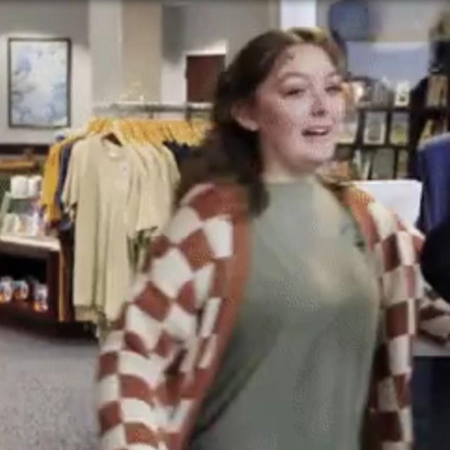 Blurry image of a young woman in front of a doorway.