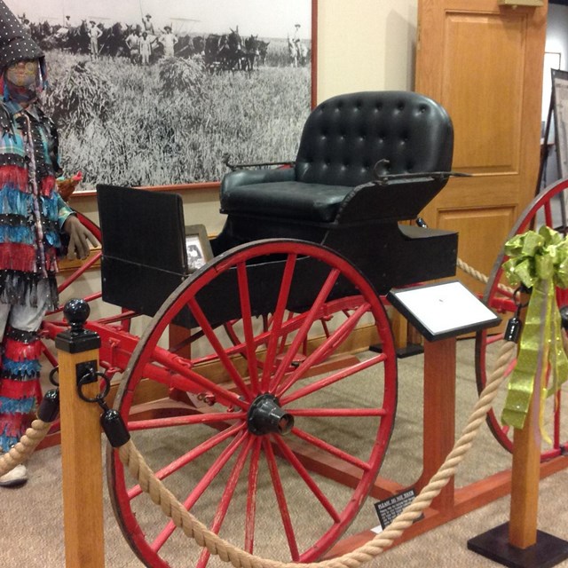 A horseless buggy on display