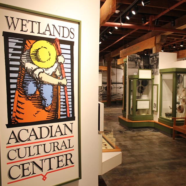 museum entrance sign with display cases in distance