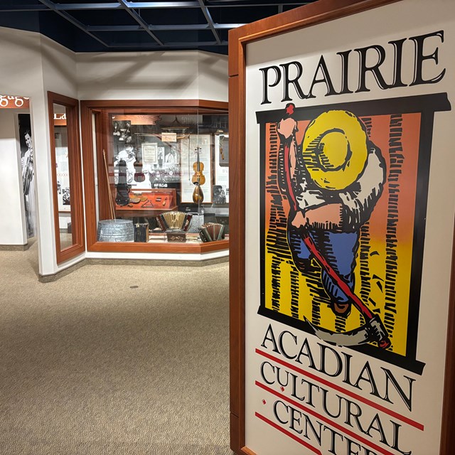 museum entrance sign with music exhibit cases in the distance