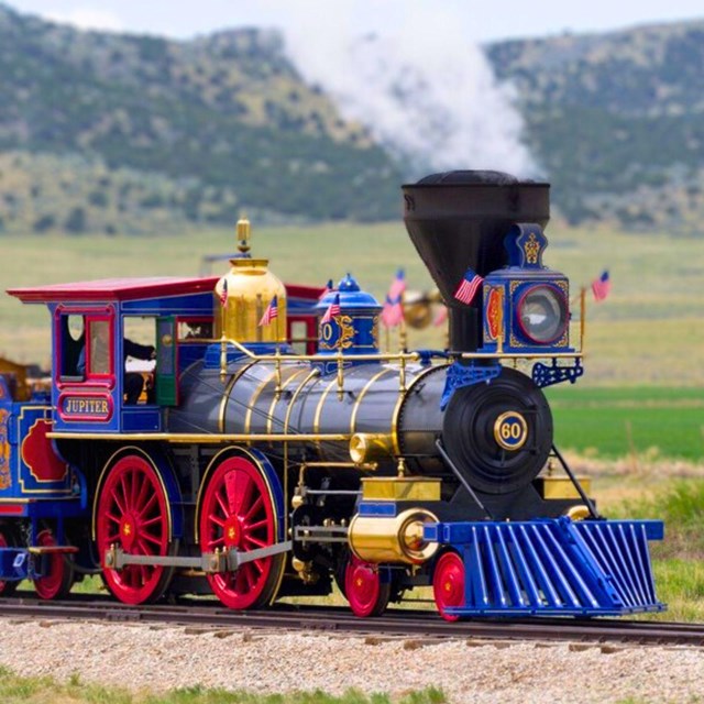 Historic blue, red, and black Jupiter train on the tracks. 