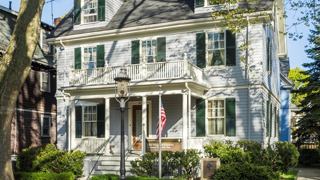 The front of 83 Beals St. The house is dappled with shadows from the trees. 