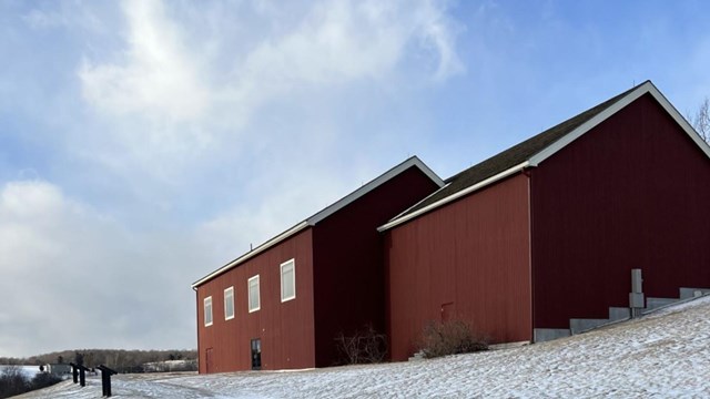 Red barn building in the snow.