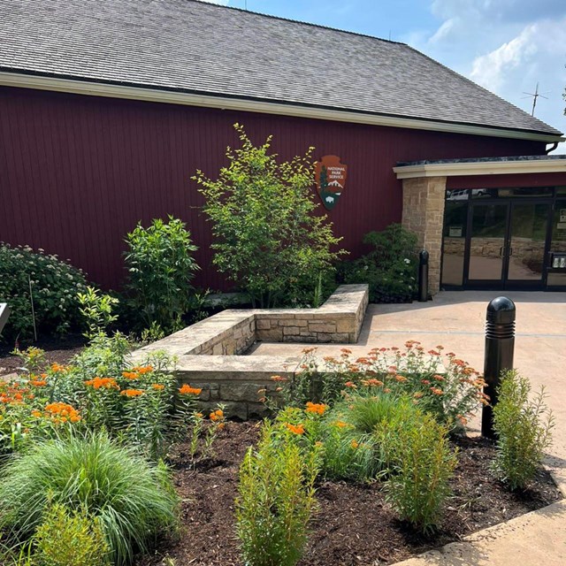 A red barn with plants
