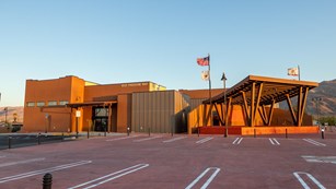 A building and parking lot. 6533 Freedom Way as well as Joshua Tree Cultural Center is inscribed on 