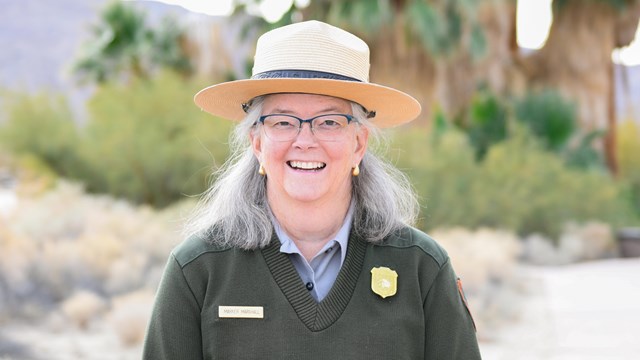 A ranger smiling towards the camera