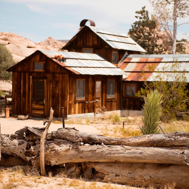 A wooden house with a wooden fence in the foreground located in Keys Ranch 