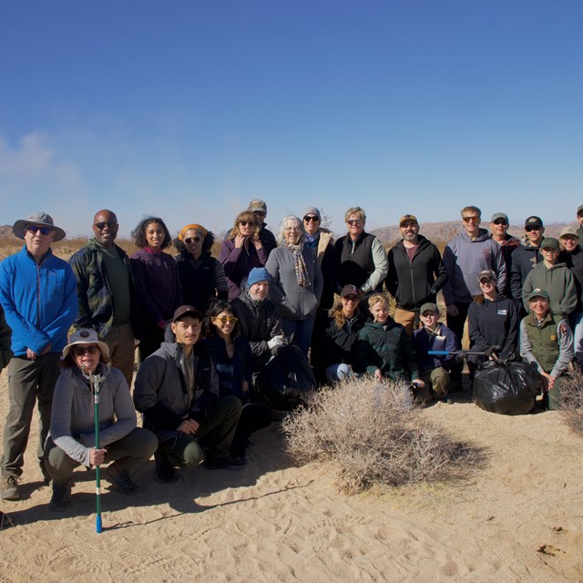 A group of volunteers smile at camera.