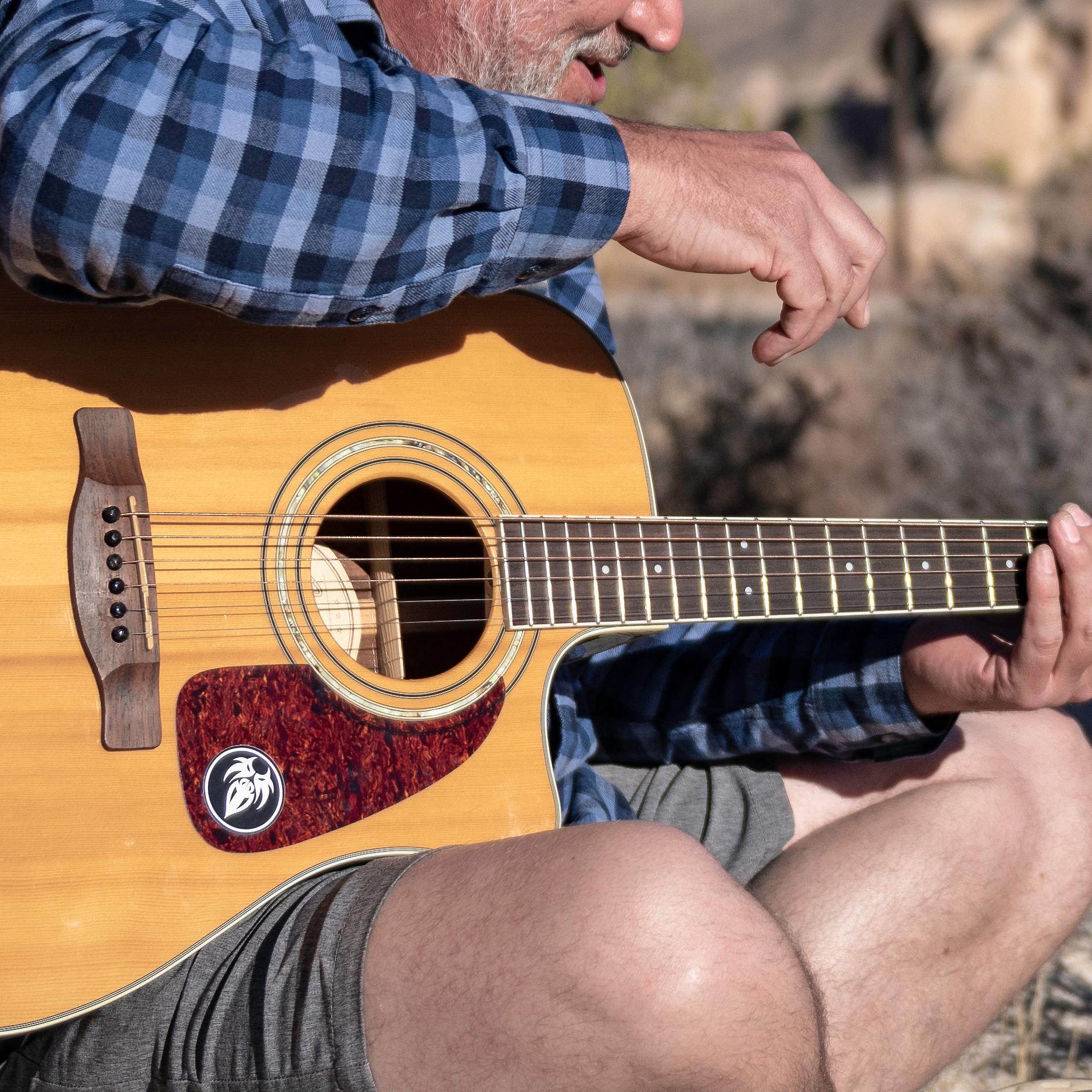 Two guitar players in front of Intersection Rock