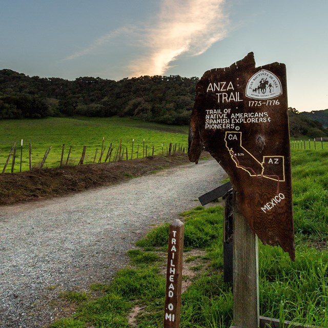 A sign post reading Anza Trail. Trail of Native Americans, Spanish Explorers, and Pioneers. 