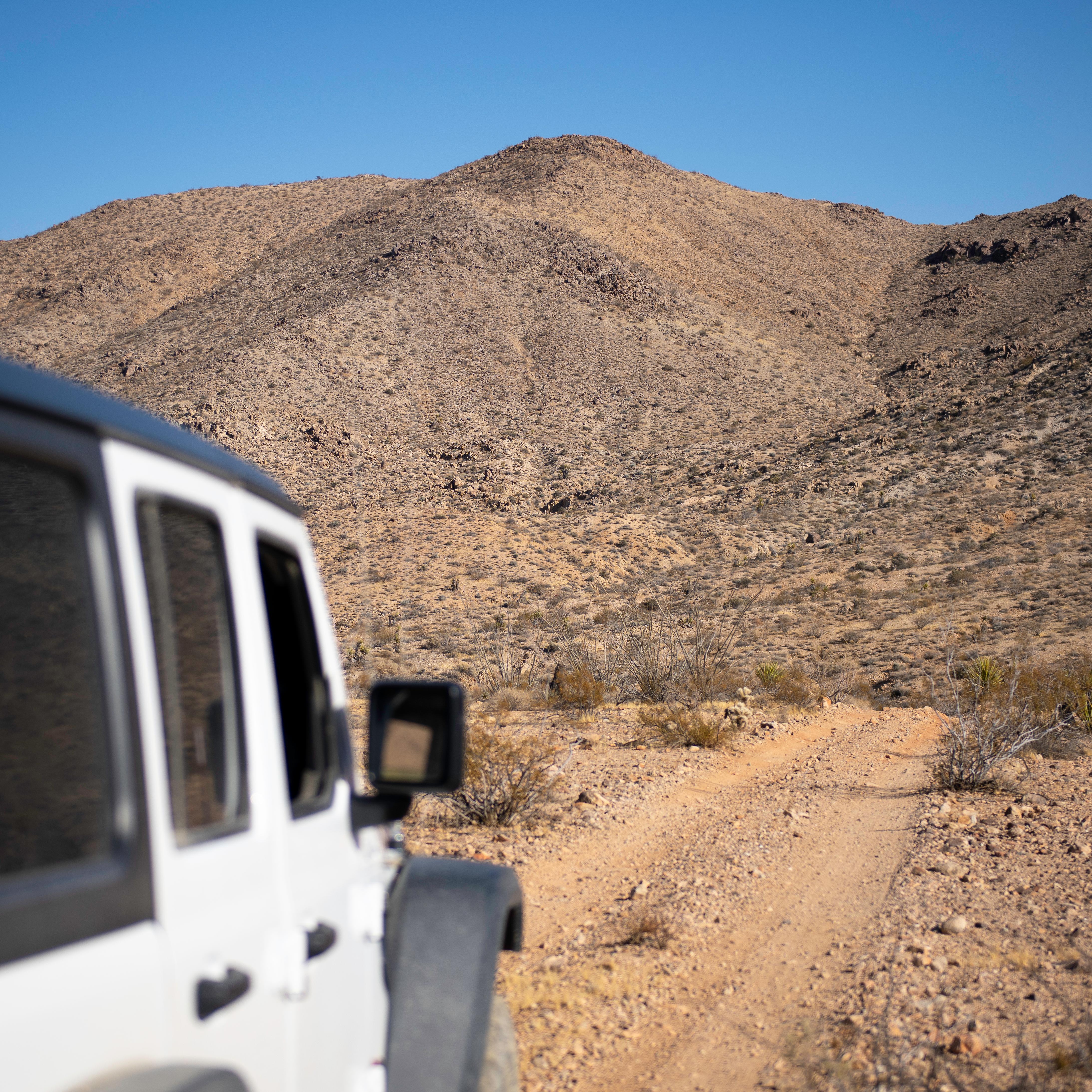 A jeep driving on a dirt road