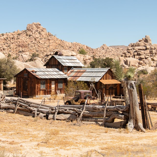 Historic structure surrounded by desert landscape.