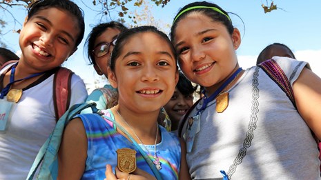A group of children smile for the camera.