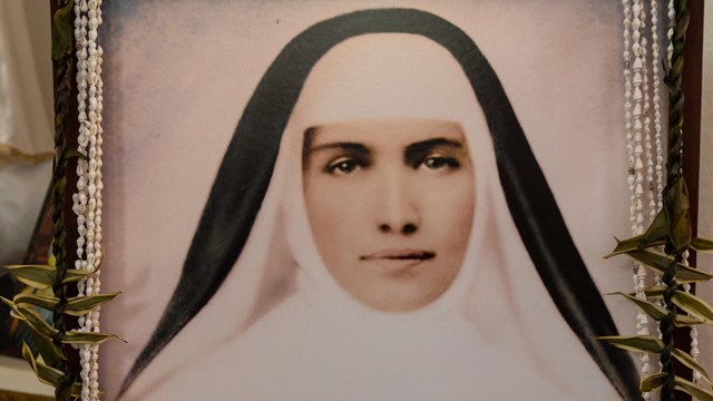 A black and white portrait of a nun 