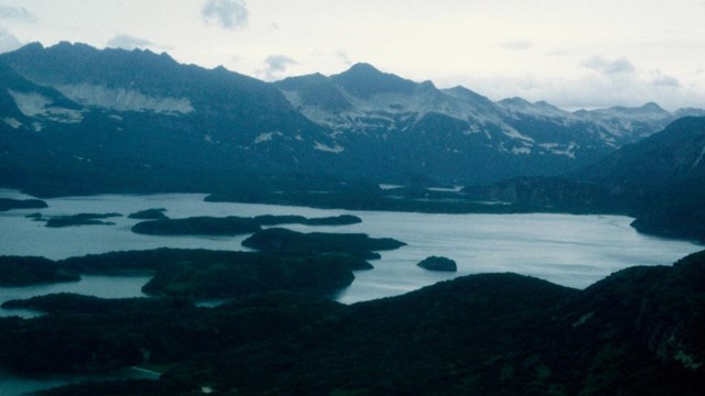 A view of a bay with mountains.