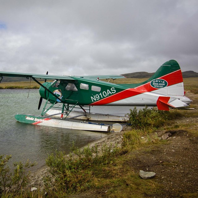 a float plane at the edge of a lake