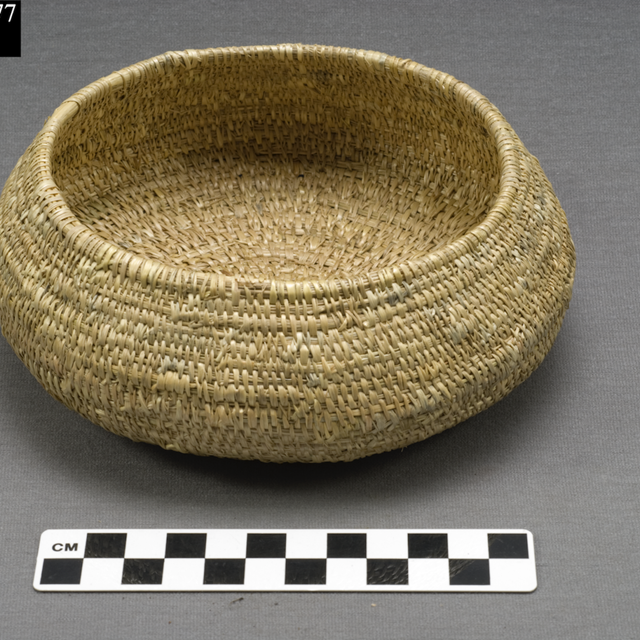 A woven bowl next to a ruler