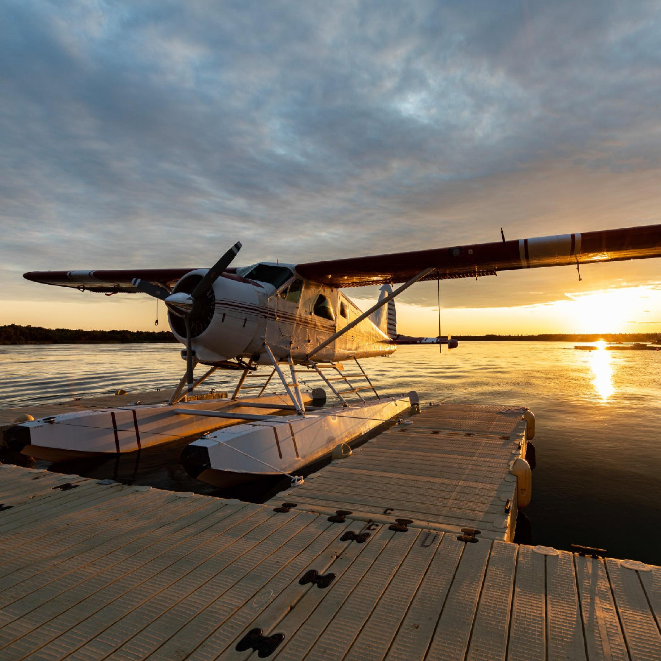 a float plan sits on the water at sunrise