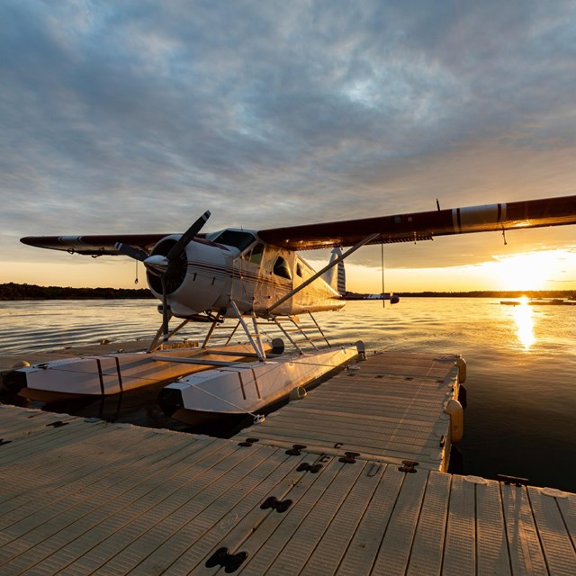 a float plan sits on the water at sunrise