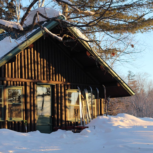 A log cabin in the snowy woods.