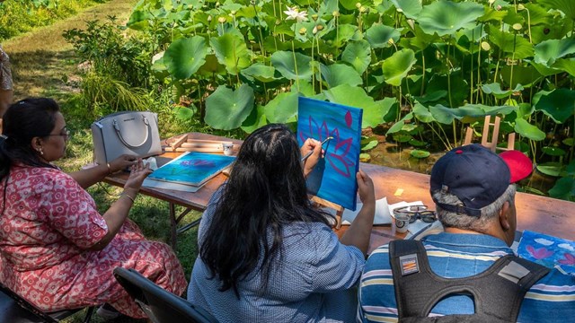 People painting lotus flowers