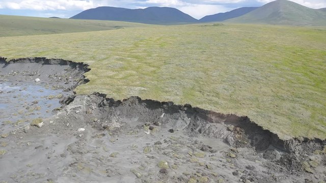 A photo of a landscape showing retrogressive thaw slump