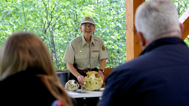 A park ranger with bear skull presenting to visitors.