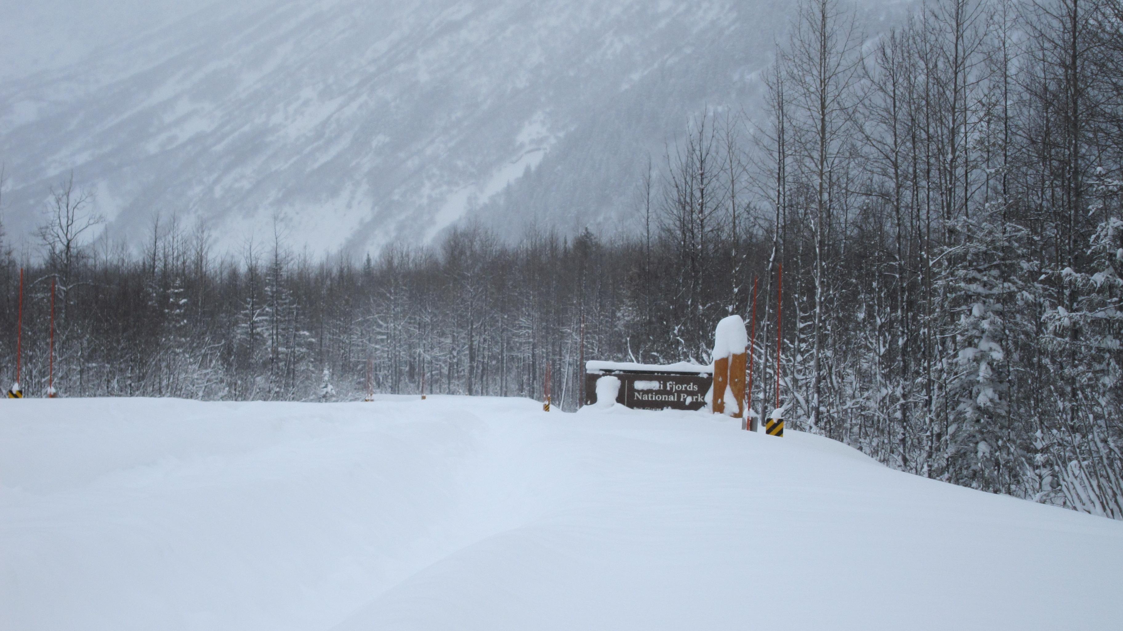 Kenai Fjords National Park sign and road under snow